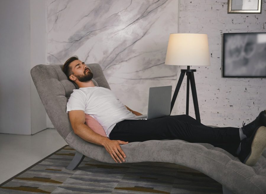 candid-shot-unshaven-young-male-shoes-lying-comfortably-gray-couch-with-portable-computer-his-lap-having-nap-meditating-keeping-his-eyes-closed-listening-relaxing-music_343059-798